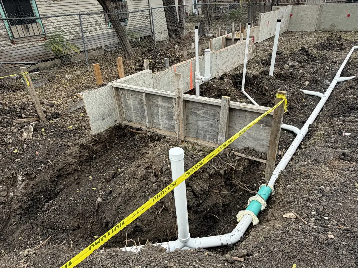 Concrete retaining wall with drainage on a sloped lot